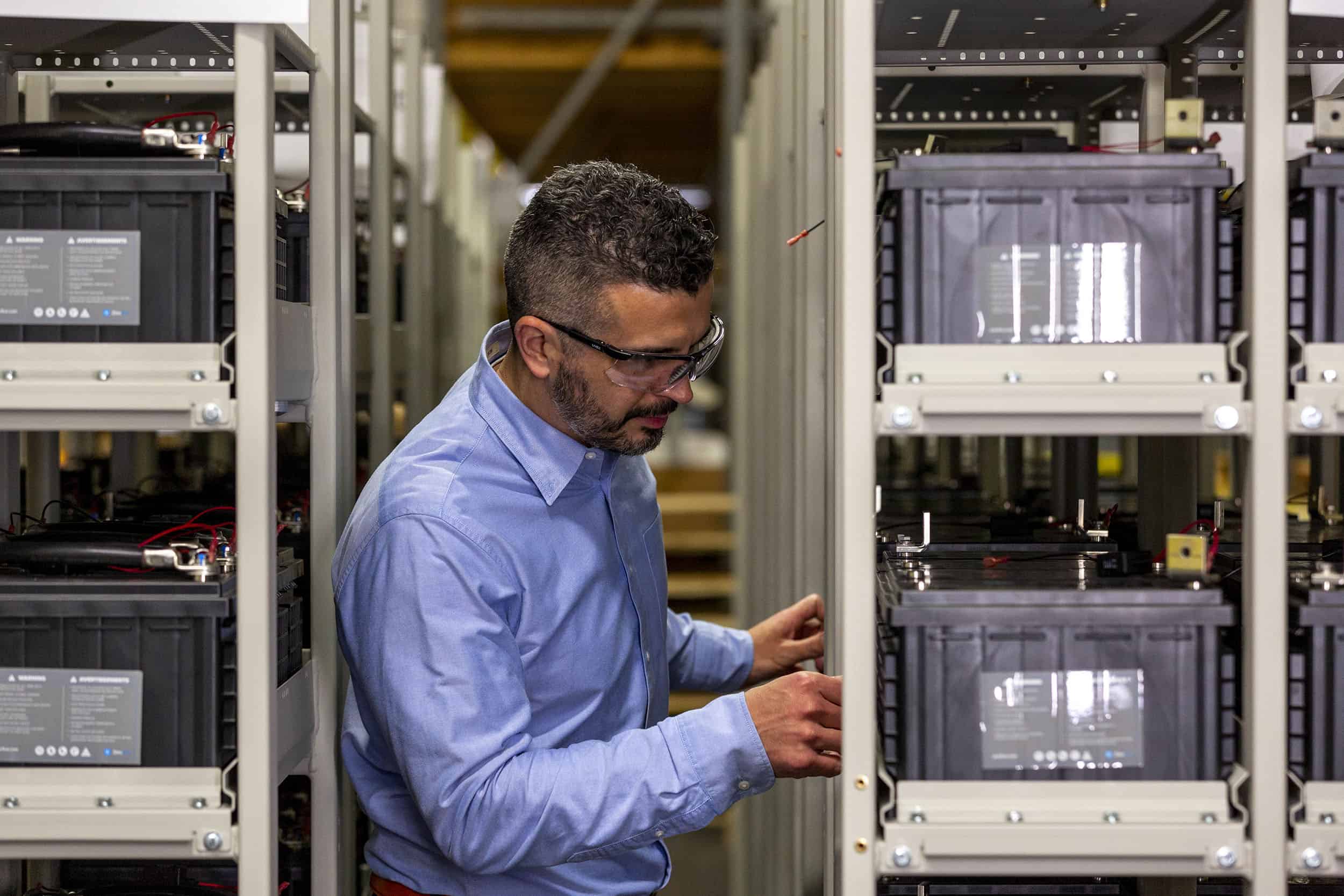 Data center technician reviewing nickel-zinc battery cabinet